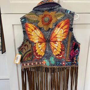 Upcycled denim vest with butterfly appliqué and long leather fringe